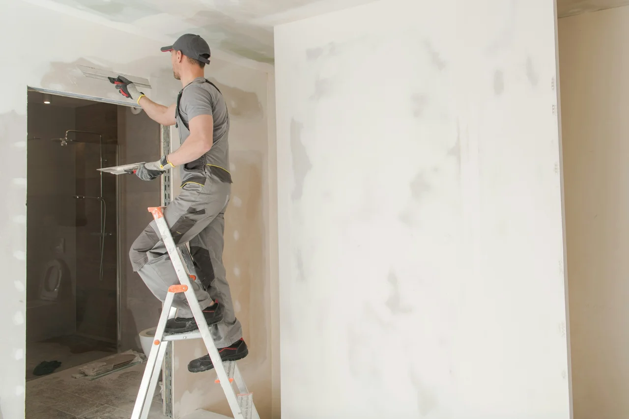 Professional house painter working on roof in Modesto, CA
